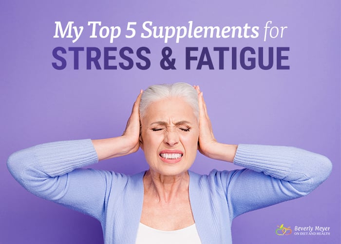An older woman against a colorful lavendar background is holding her head with her eyes tightly shut.